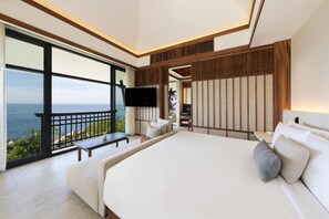 A modern bedroom with a large bed, a TV mounted on the wall, and a balcony with a view of the ocean. - Banyan Tree Cabo Marques (Acapulco)