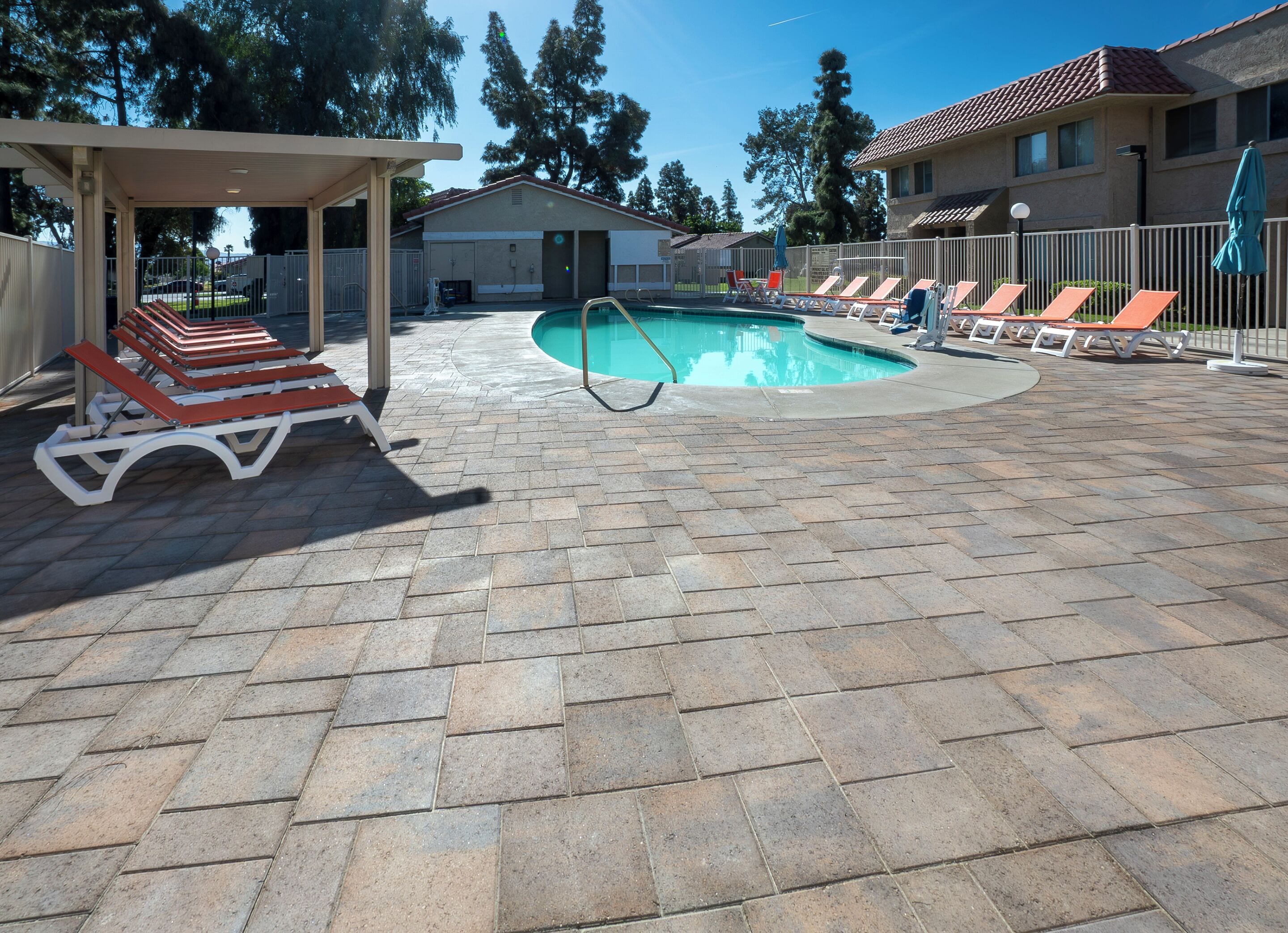 Una piscina al aire libre, sillones reclinables de piscina