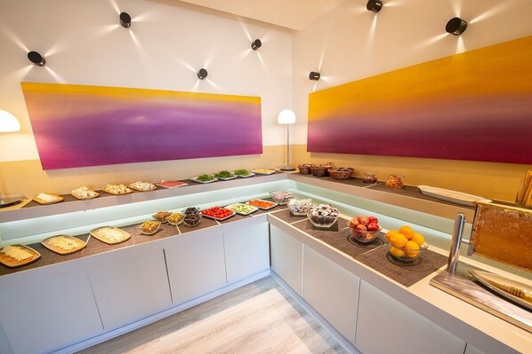 A buffet setup with various food items and a modern interior design.