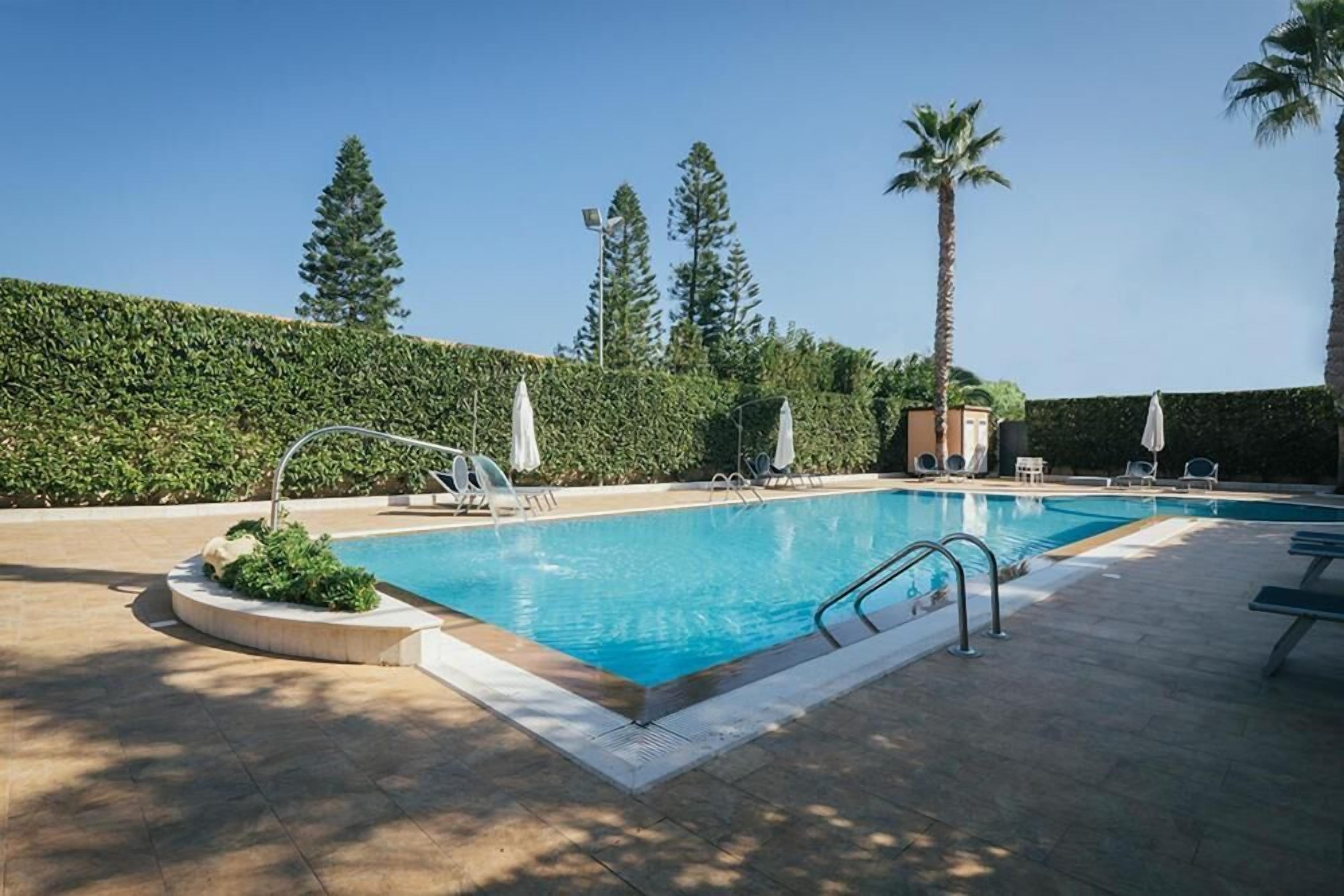 Outdoor pool, open 9:30 AM to 7:00 PM, pool umbrellas, sun loungers