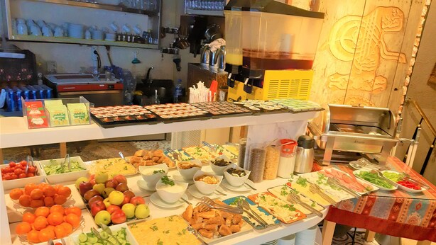 Un bufé con diferentes opciones de comida y una máquina de café.