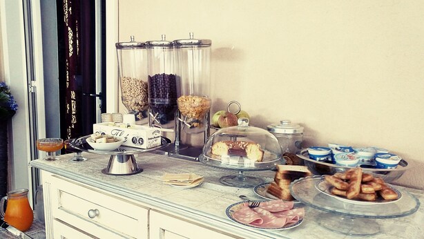 A breakfast buffet with various food items and condiments. - Dimora Annulina B&B (Palermo)
