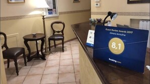 A hotel reception area with a guest review board displaying an 8.1 rating. - Dimora Annulina B&B (Palermo)