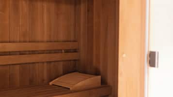 A wooden sauna with benches and a bench seat.