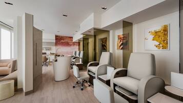 A modern interior with a reception desk, seating area, and artwork on the walls.