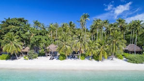 A beach resort with overwater bungalows, clear turquoise waters, and palm trees. - Haadtien Beach Resort (Koh Tao)