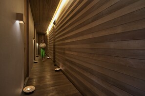 A hallway with wooden paneling and a person walking away. - Haadtien Beach Resort (Koh Tao)