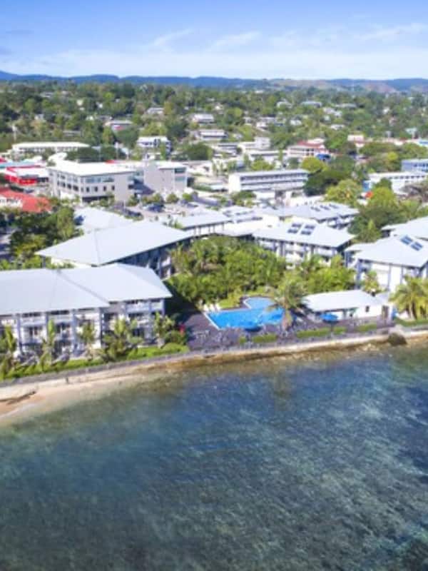 Enjoy stunning ocean views from this beachfront hotel's modern buildings, surrounded by lush greenery and a serene environment.