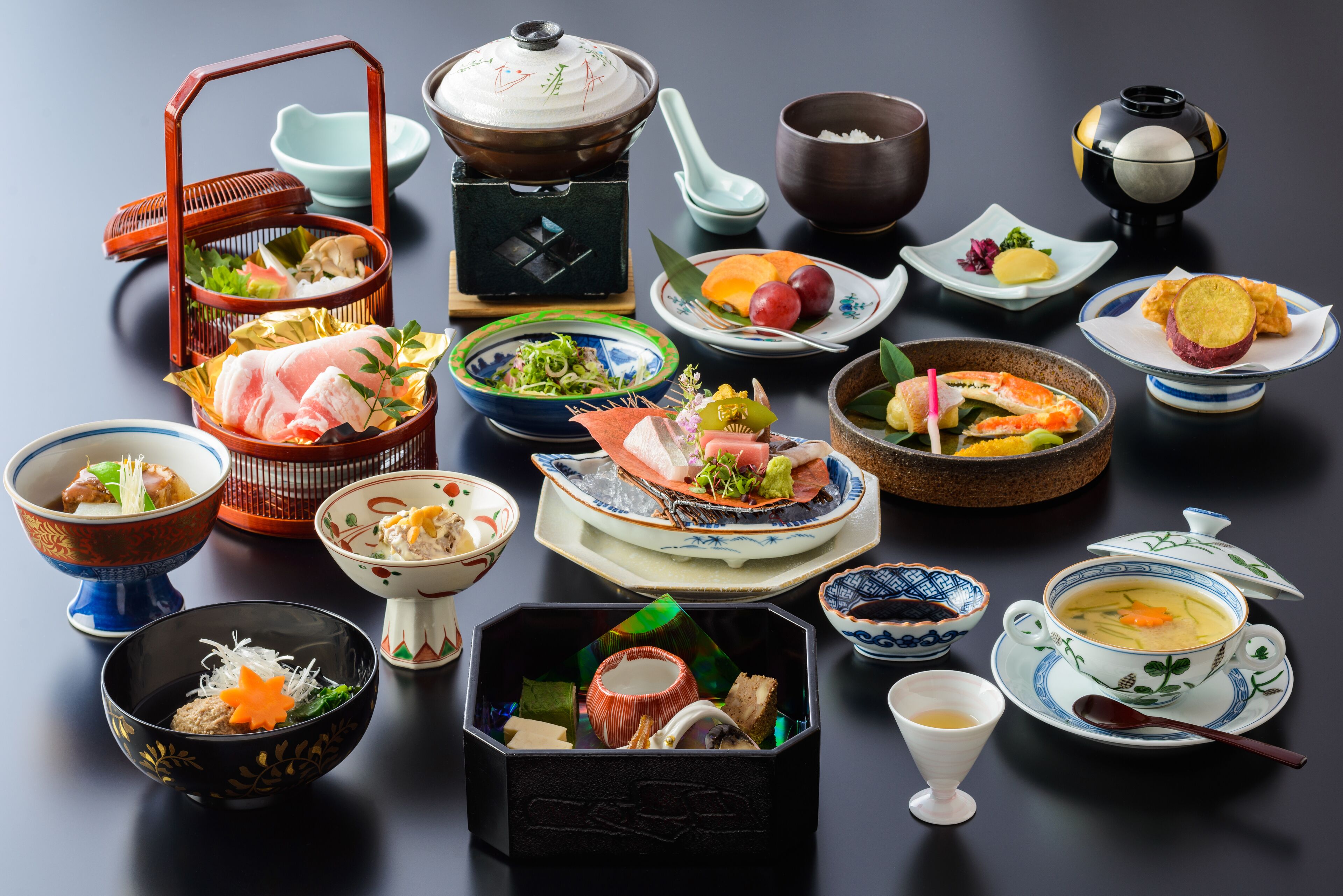 A variety of traditional Japanese dishes and utensils on a table.