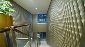 A modern interior with a staircase, metal railings, and textured walls. - PARK HOTEL Cawang - Jakarta (Jakarta)