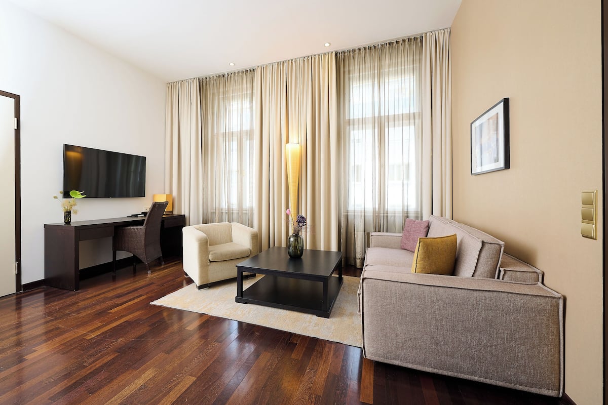 Junior Suite, 1 King Bed | Living area | 35-inch flat-screen TV with satellite channels, TV