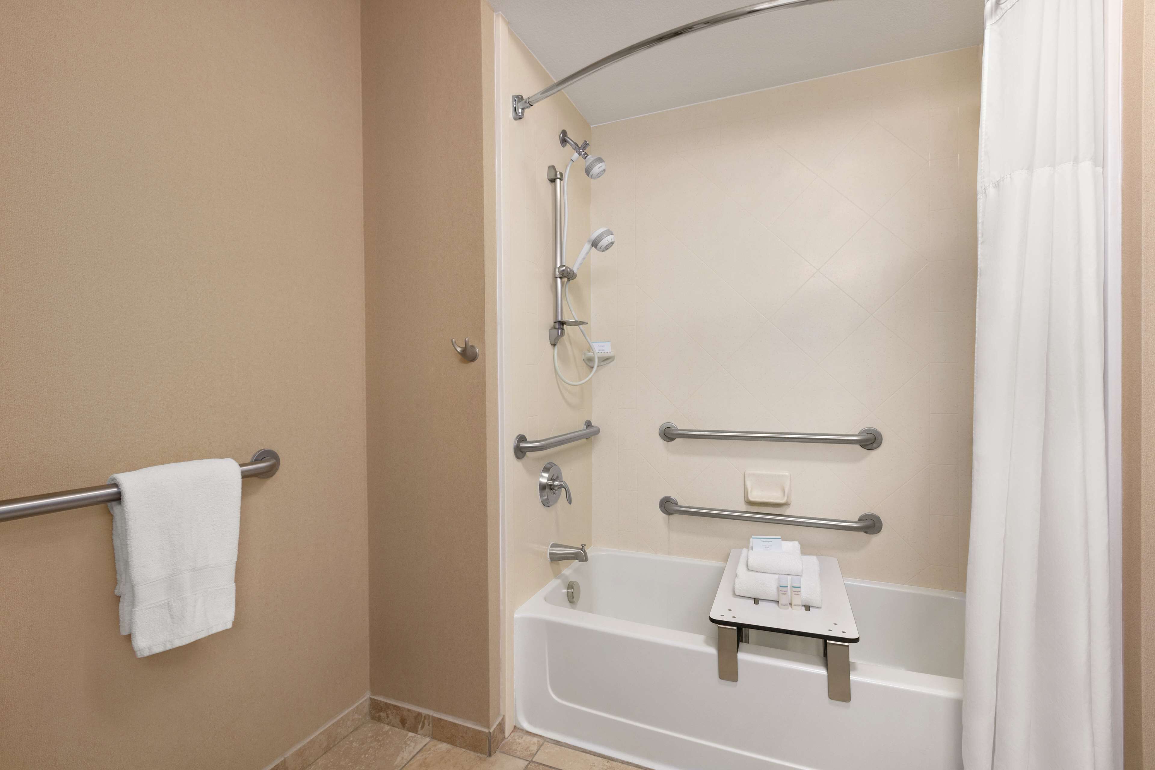 bathtub, designer toiletries, hair dryer, towels