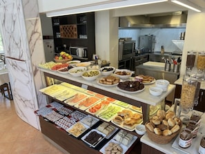 A buffet with various food items and condiments. - Anadolu Hotel (Istanbul)
