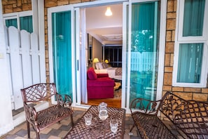 A patio with a table, two chairs, and a bench.