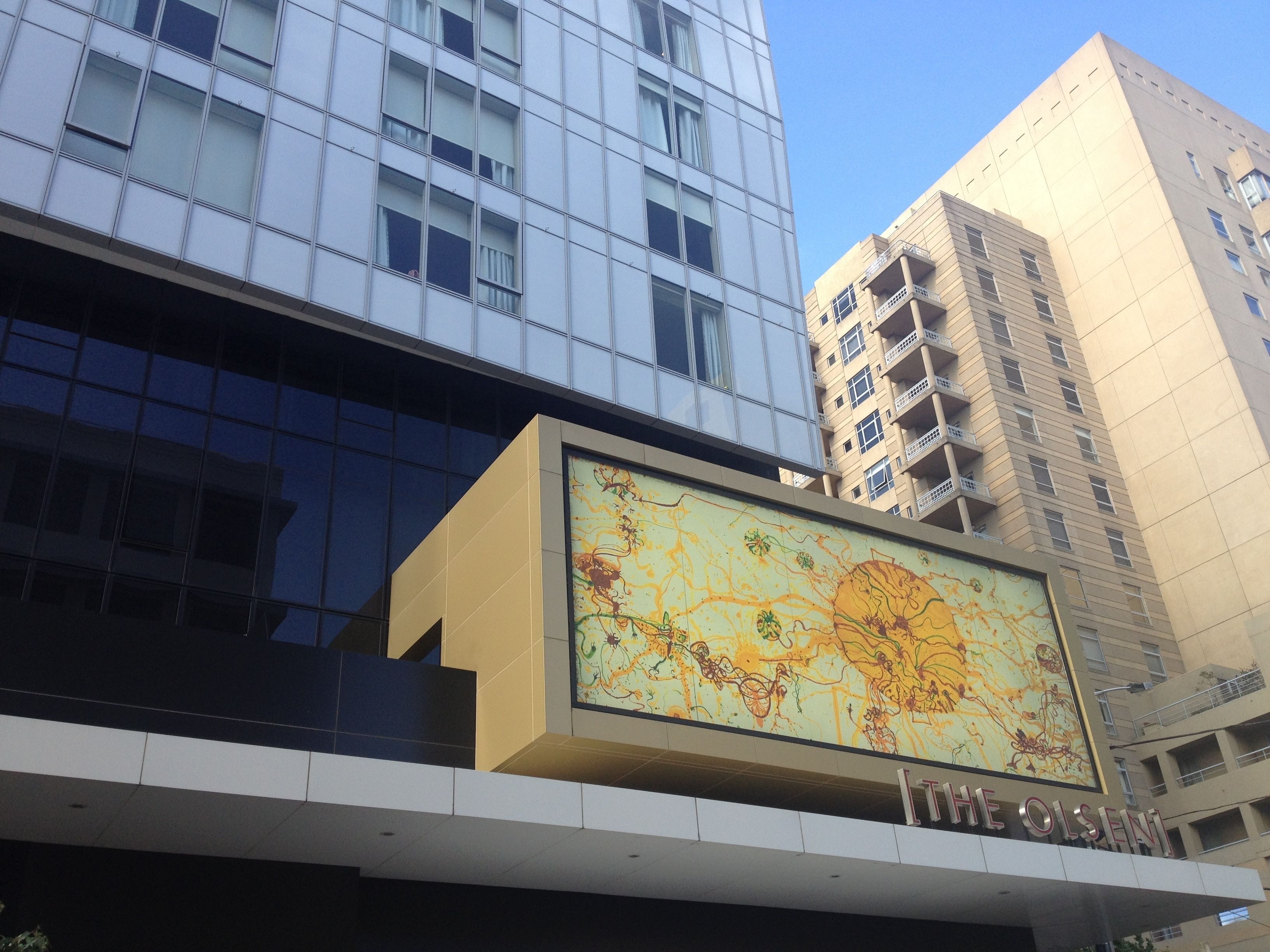 A modern building with a large, colorful mural on the facade.