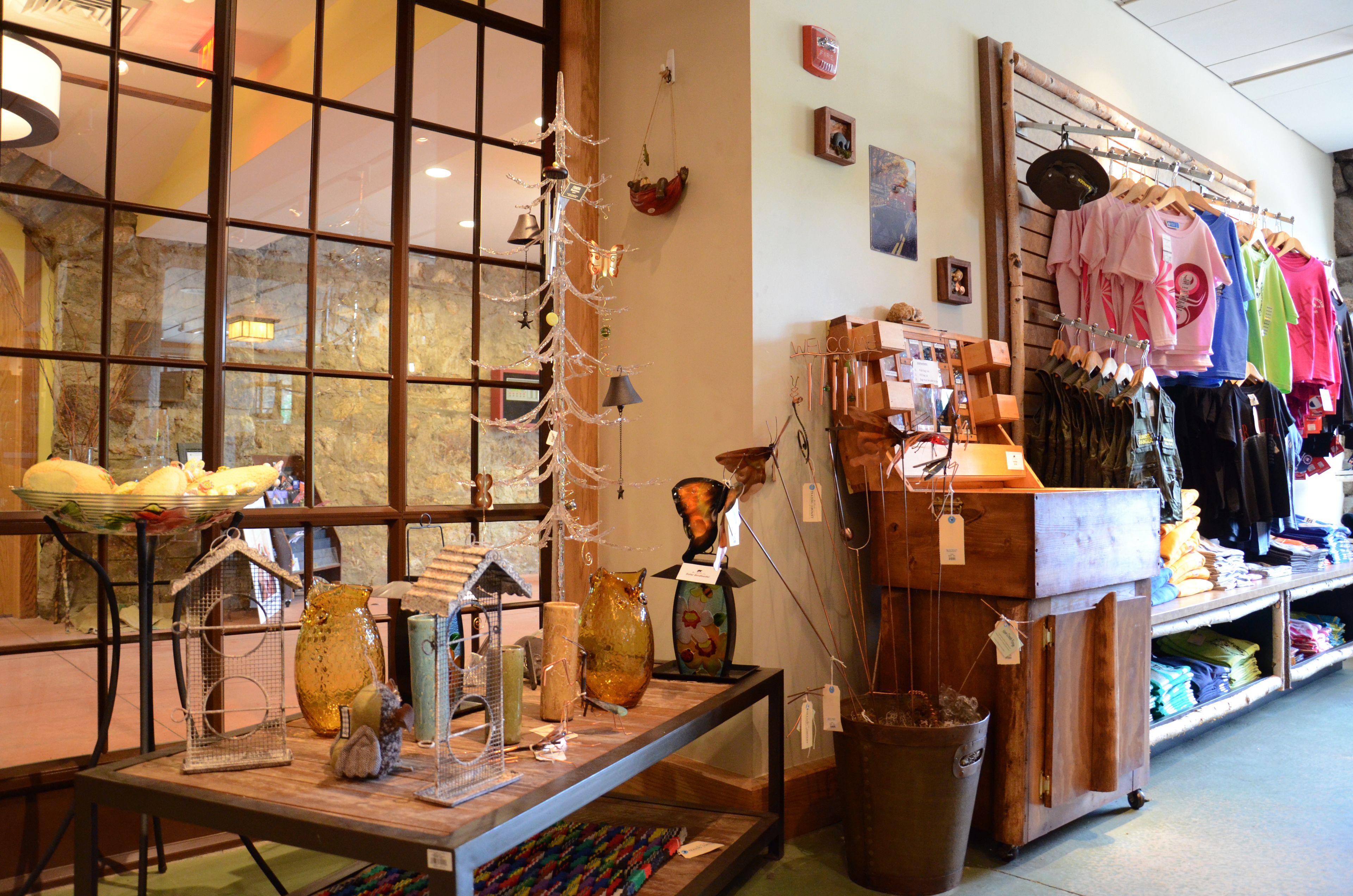 A store with various items on display, including glassware and clothing.
