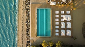 Seasonal outdoor pool, open 9:00 AM to 8:00 PM, pool loungers