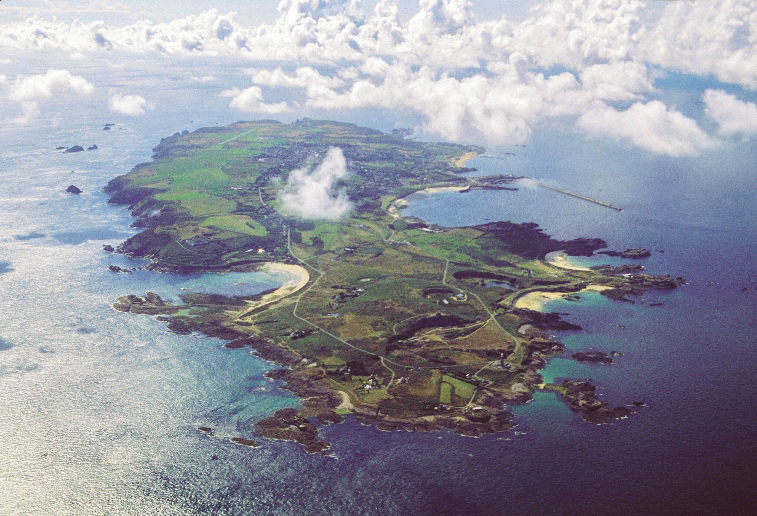 An aerial view of an island with a central town, surrounded by water and connected by bridges.
