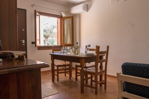 Basic Apartment, Kitchenette | Living area | Flat-screen TV - Residence Cala Viola (Orosei)