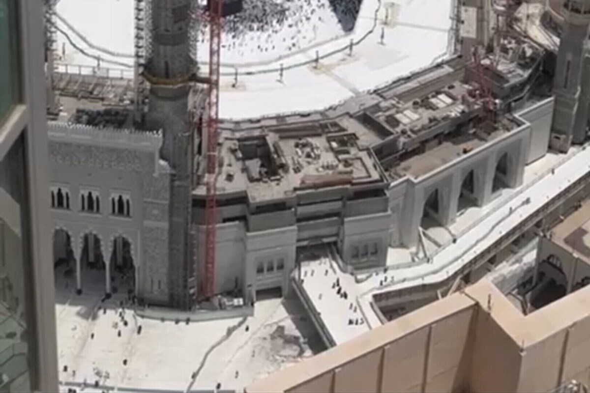 A large, circular building with a central courtyard surrounded by multiple minarets.