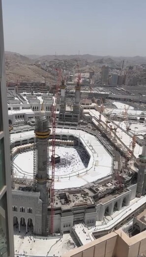 A large, circular building with a central courtyard surrounded by multiple minarets. - Al Marwa Rayhaan by Rotana (Makkah)