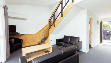 Two Bedroom Apartment | Living area | 32-inch flat-screen TV with satellite channels, TV, Netflix