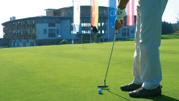 Enjoy a round of golf with a view of the clubhouse in the distance.