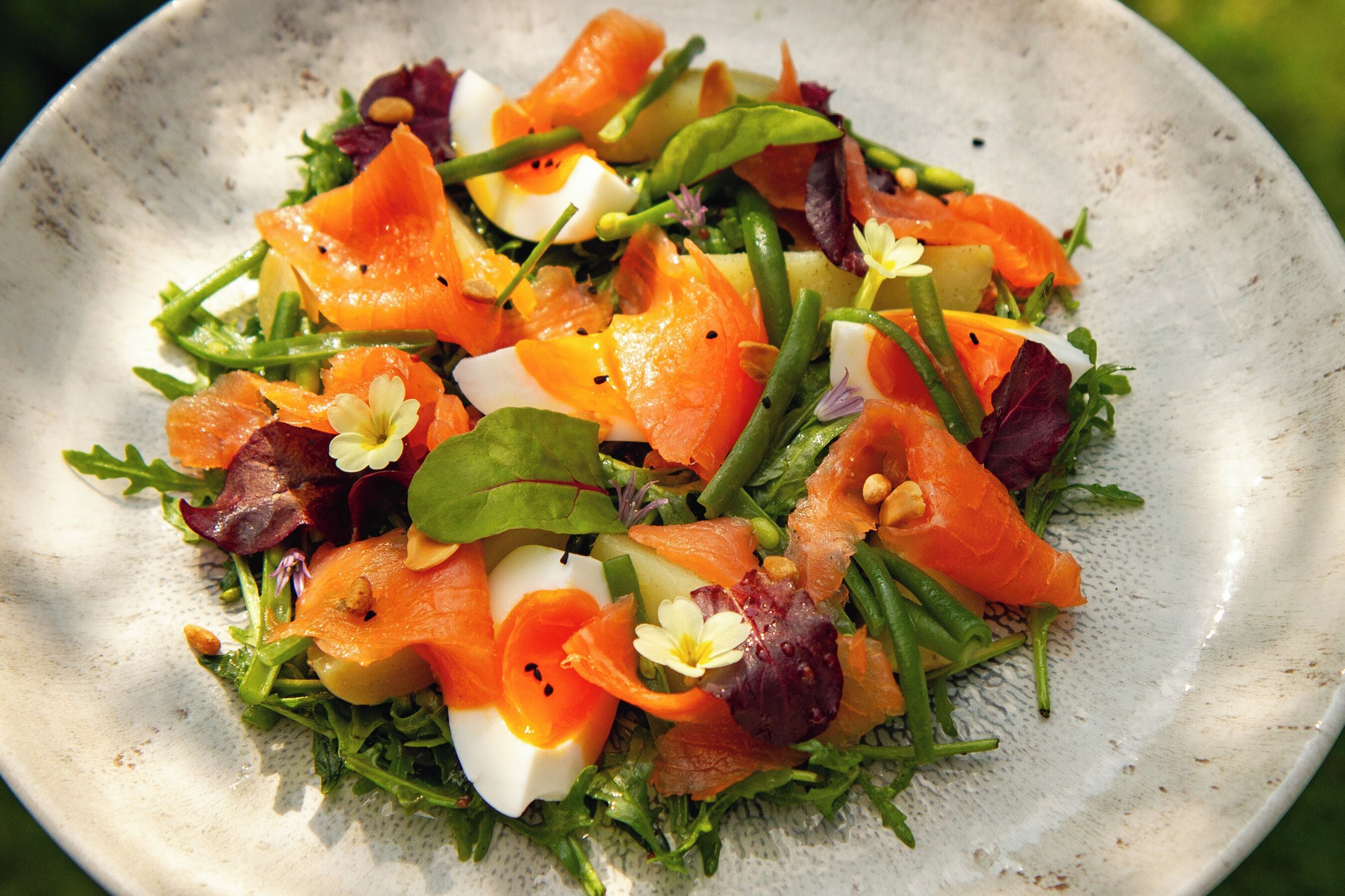 A salad with various ingredients on a plate.