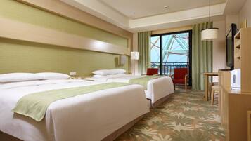 A hotel room with two beds, a desk, a chair, a TV, and a view of a Ferris wheel.