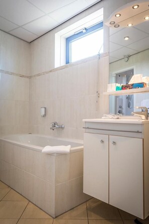 Separate bathtub and shower, jetted bath, free toiletries, hair dryer - Hotel De Vlijt Texel (De Cocksdorp)