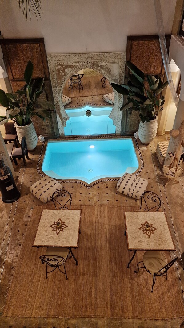 A pool area with two pools, seating, and potted plants. - Riad Des Arts (Marrakech)