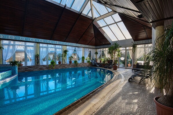 Indoor pool, seasonal outdoor pool, pool umbrellas, pool loungers