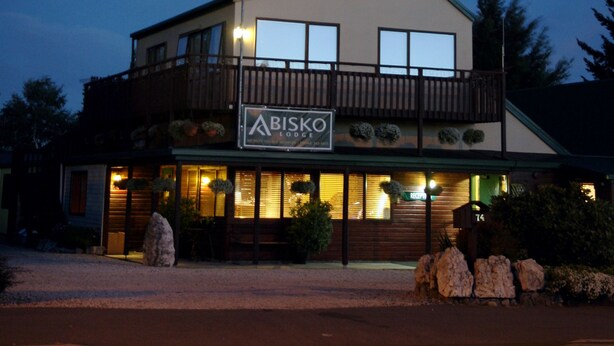 A two-story building with a sign reading "ABISKO Lodge." - Abisko Lodge (Methven)