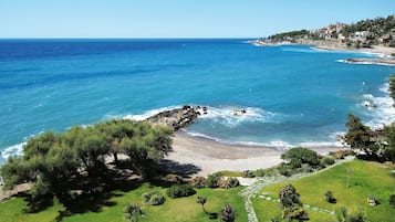 Private beach, black sand, sun loungers, beach umbrellas