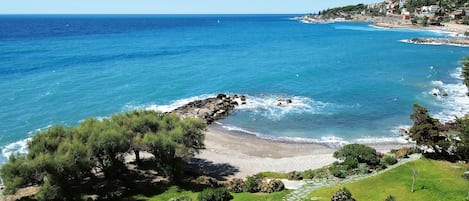 Private beach, black sand, sun loungers, beach umbrellas