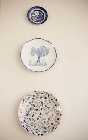 Three ceramic plates with blue designs on a plain background.