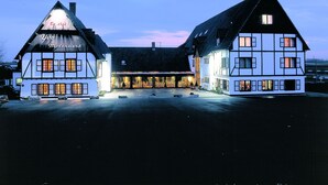 A traditional European building with a central entrance and two wings, likely a hotel or inn. - Malpertuus (Riemst)