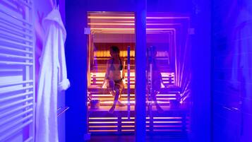 A person walking through a hallway with a modern, geometric design and illuminated lines.