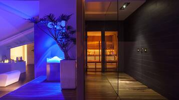 A modern spa area with a wooden floor, a reception desk, and a plant.