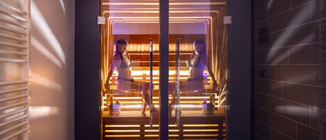 A modern elevator with glass doors and a wooden interior.