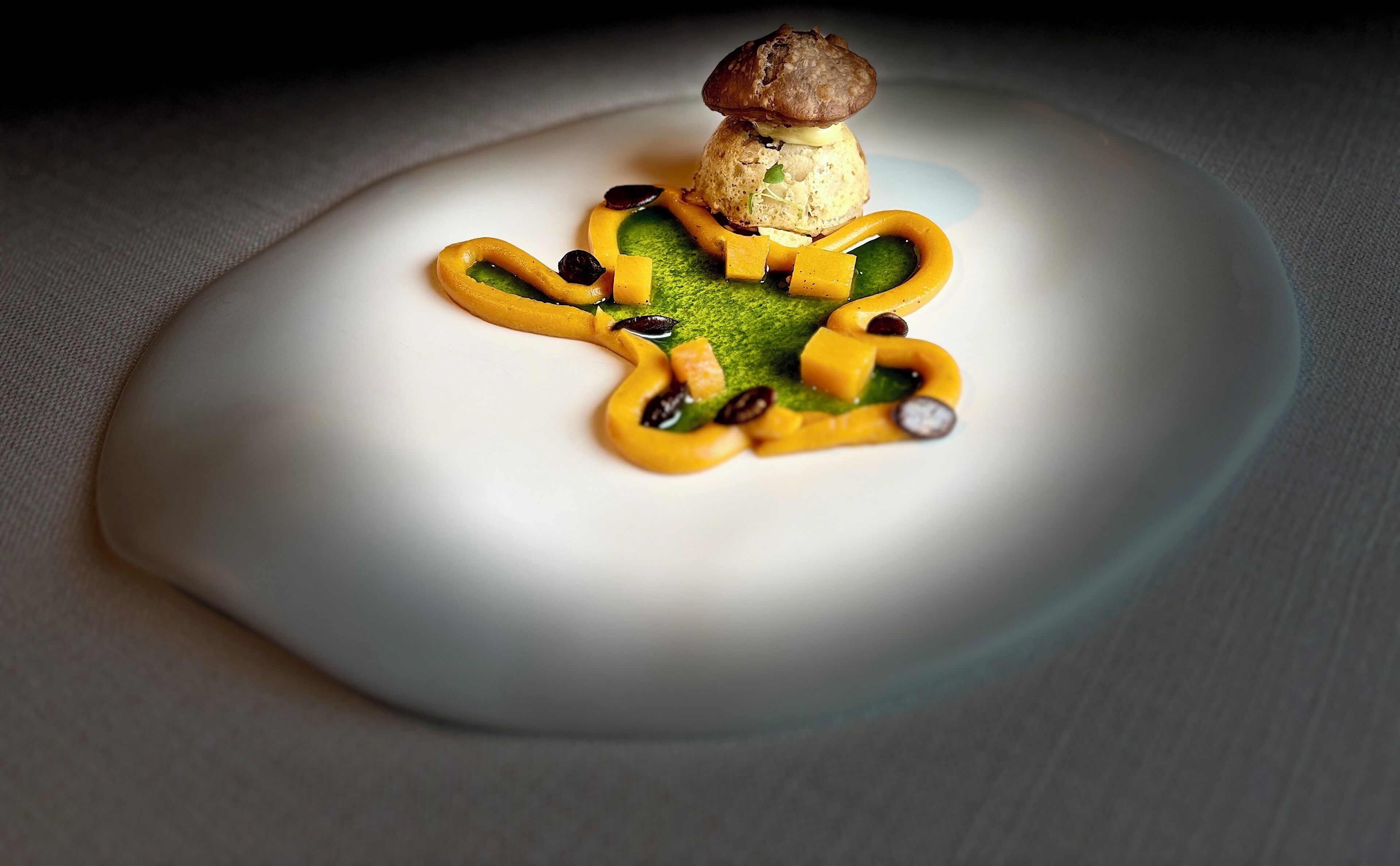 A dessert on a white plate with a mushroom on top.
