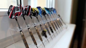 A display of darts with various designs on a transparent stand.