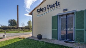 Eden Park Tuscany Resort with a clear sky, a chimney in the background, and a potted plant in front. - Eden Park Resort (San Giuliano Terme)