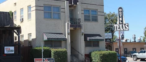 A two-story building with a sign indicating it's a hotel in Texas.