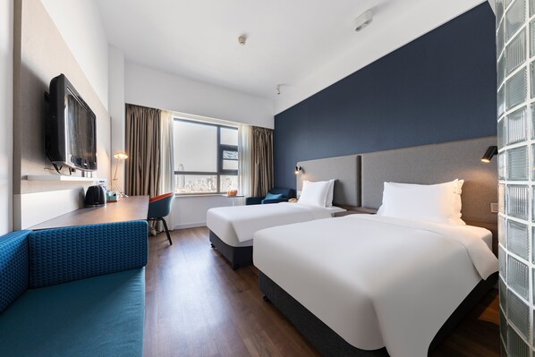 A hotel room with two beds, a sofa, a desk, a TV, and a window with curtains. - Holiday Inn Express Suzhou Changjiang by IHG (Suzhou)