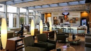 A modern bar area with seating and a bar counter. - ISG Sabiha Gokcen Airport Hotel - Special Class (Istanbul)