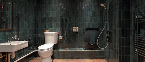 Un baño moderno con inodoro, lavamanos y zona de ducha.