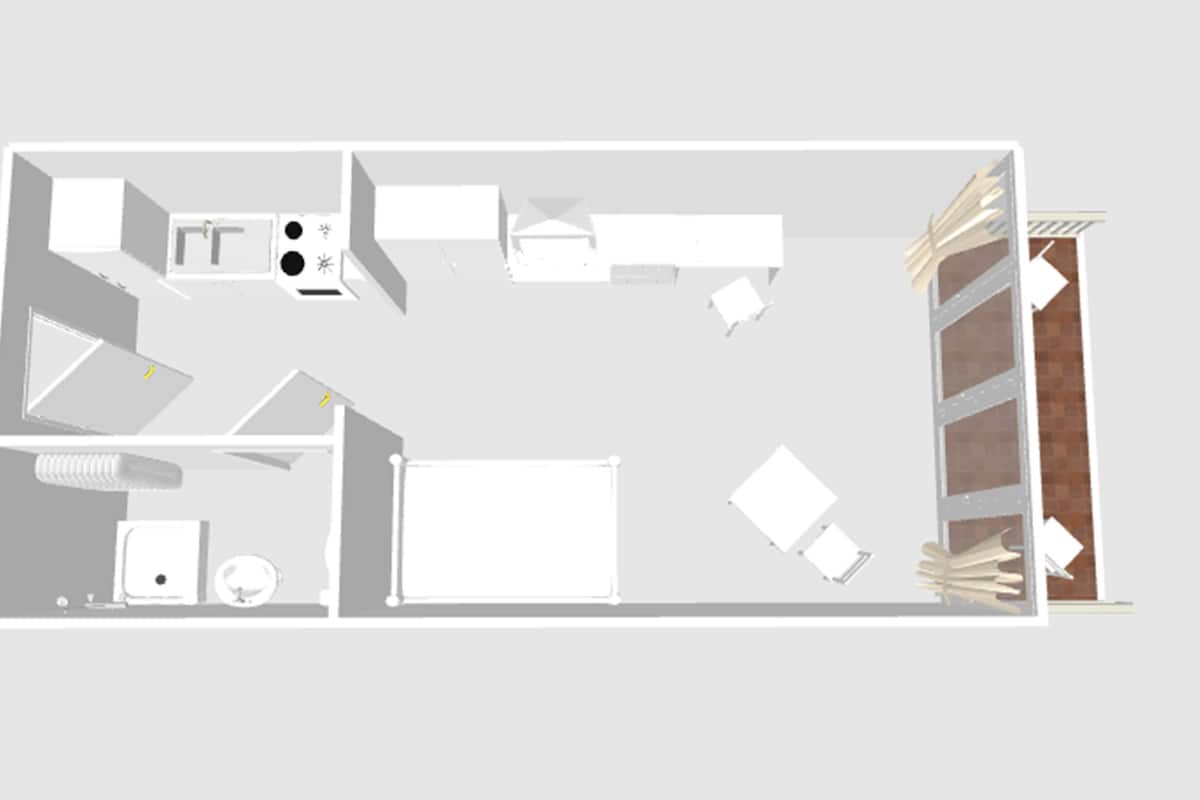 A floor plan of a hotel room with a bed, a desk, a chair, a wardrobe, and a bathroom.