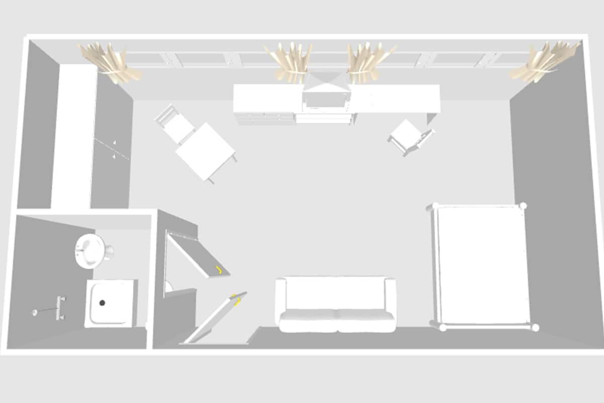 A hotel room layout with a bed, a desk, a chair, a sofa, a wardrobe, a bathroom, and a small table.