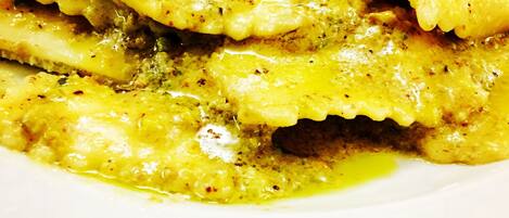 A plate of food with a yellow sauce and herbs.